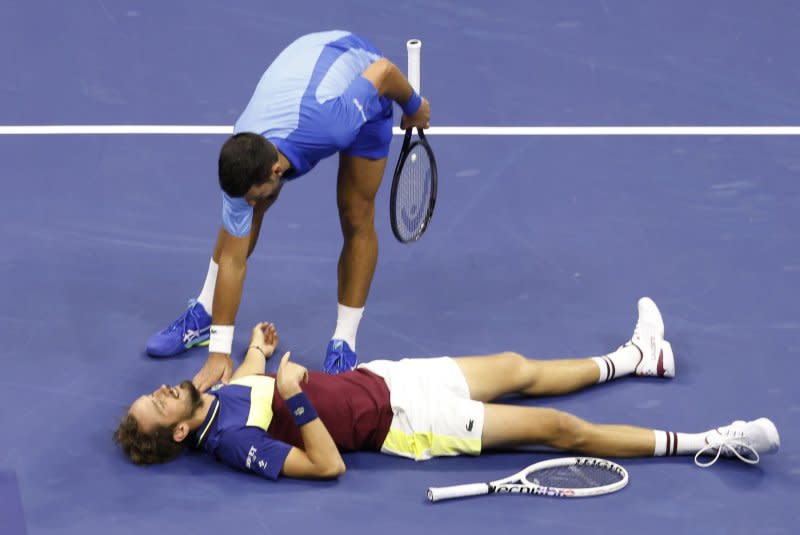 Novak Djokovic (top) of Serbia checks on Daniil Medvedev of Russia as Medvedev lies on the court after a long point in the men's final of the 2023 U.S. Open on Sunday in Flushing, N.Y. Photo by Corey Sipkin/UPI