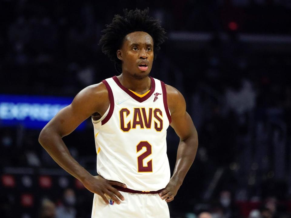 Collin Sexton looks on while standing with his hands on his hips during a game.