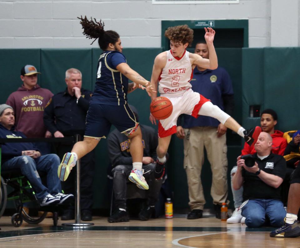 From left, Newburgh's Tajir Walker (4) and North Rockland's Connor Wein (2) battle for loose ball during the boys Class AA regional final  playoff game at Yorktown High School March 11, 2023. North Rockland won the game 53-46.