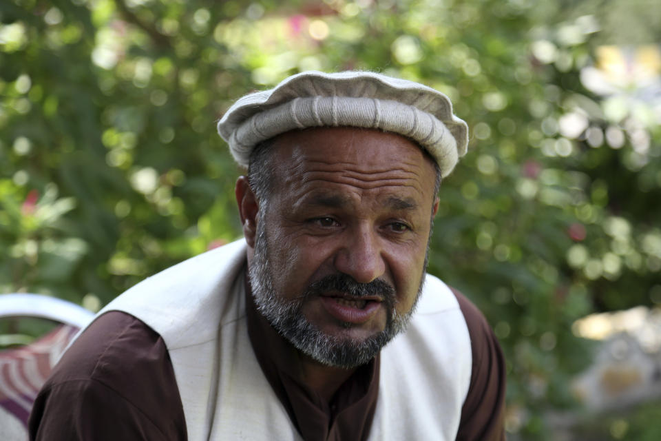 In this Tuesday, Oct. 1, 2019, photo, Aziz Rahman a village elder, who had contracted the farmers to harvest the pine nuts, speaks during an interview to the Associated Press in Jalalabad city east of Kabul, Afghanistan. Anger is mounting over the increasing numbers of civilians dying in misdirected US aerial strikes and heavy- handed tactics of CIA-trained Afghan force. Some Afghans calling for Americans to be tried in Afghan courts. (AP Photo/Rahmat Gul)