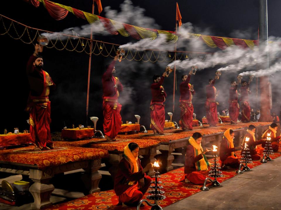 Hindu priests perform "Morning Aarati" prayers at Assi Ghat during the Ganga Aarti, a traditional and old Hindu ritual honoring the Ganges River.