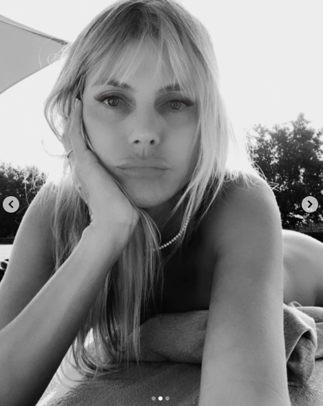 Heidi Klum pout in a black and white selfie of her nude in her garden on Instagram