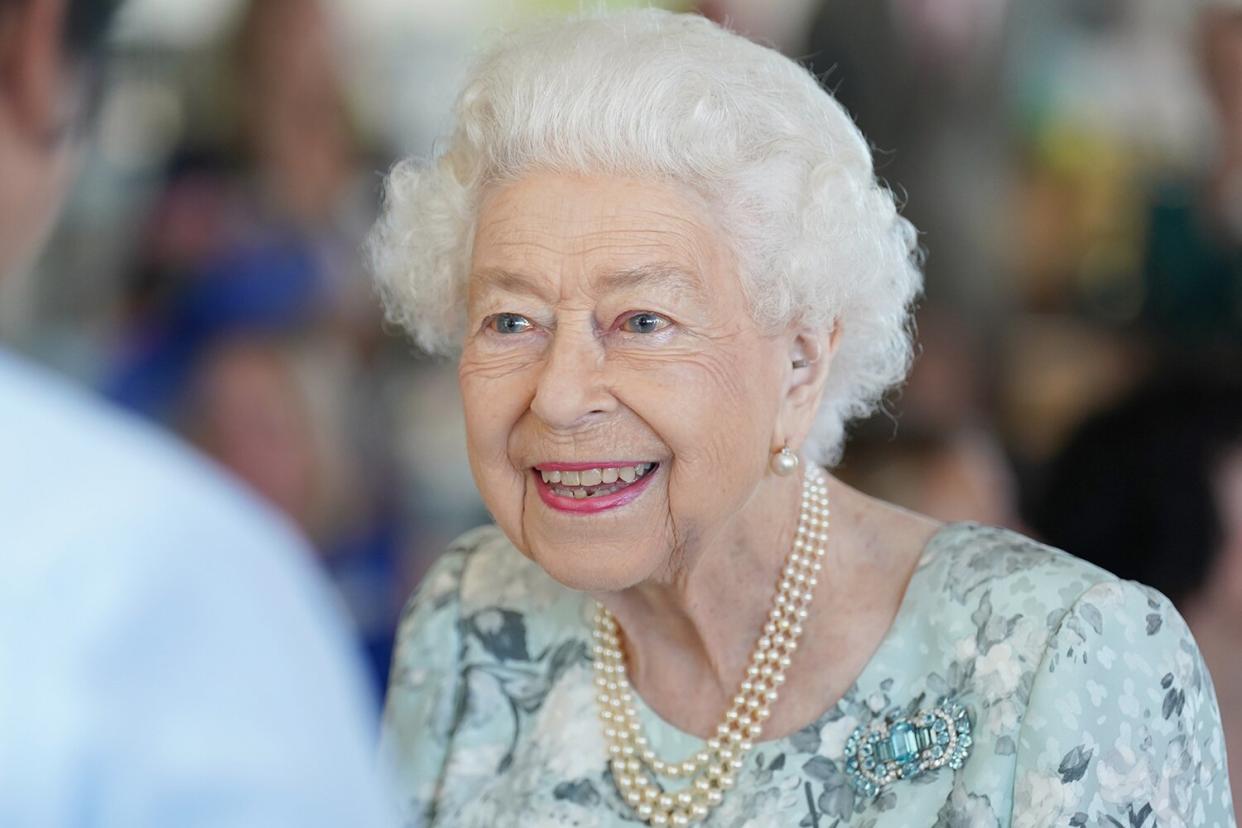 Queen Elizabeth II smiles during a visit to officially open the new building at Thames Hospice