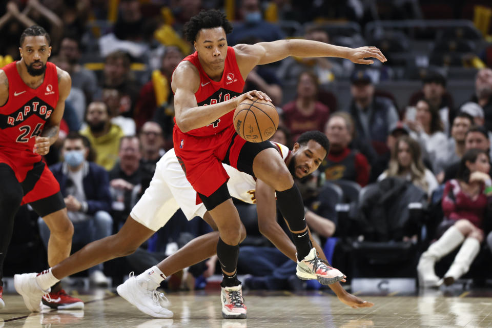 Toronto Raptors' Scottie Barnes (4) brings the ball upcourt against Cleveland Cavaliers' Evan Mobley during the second half of an NBA basketball game, Sunday, March 6, 2022, in Cleveland. (AP Photo/Ron Schwane)