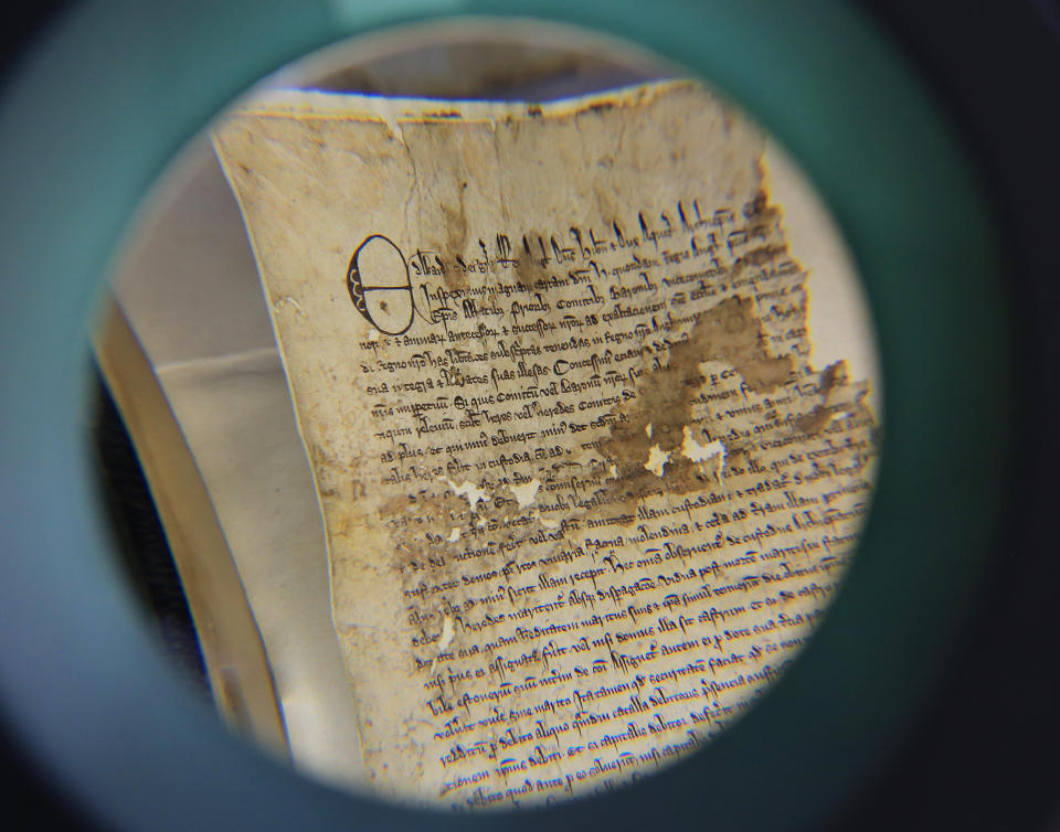 A view through a magnifying glass of part of an original Magna Carta from the issue made in 1300 by King Edward l to the borough of Sandwich in Kent which has recently been discovered in the archives at Kent County Council's Kent History and Library Centre in Maidstone.