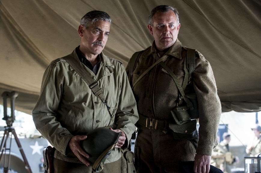 This image released by Columbia Pictures shows George Clooney, left, and Hugh Bonneville in "The Monuments Men." (AP Photo/Columbia Pictures, Claudette Barius)