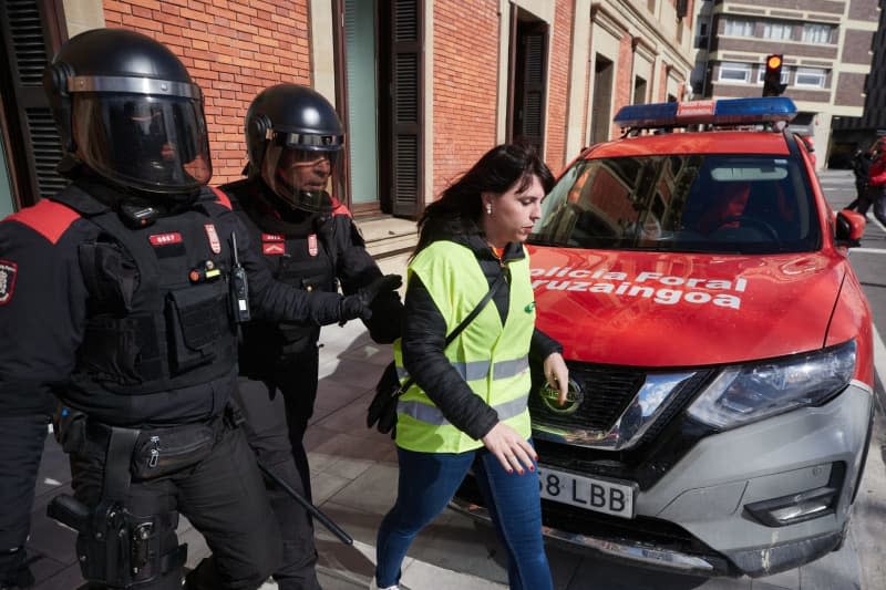 A woman is detained by the Navarra Foral Police during Farmers' protest at the back of the Parliament of Navarra, after trying to enter the Parliament while the General Budgets of Navarra for 2024 were being debated. Eduardo Sanz/EUROPA PRESS/dpa