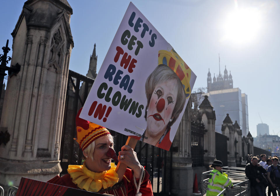 A Demonstrator protests at the entrance of the Houses of Parliament in London, Tuesday, Feb. 26, 2019. Bank of England Governor Mark Carney has warned that the Brexit uncertainty that has dogged the British economy over the past couple of years will remain even if lawmakers agree to a withdrawal agreement with the European Union in coming weeks.(AP Photo/Frank Augstein)