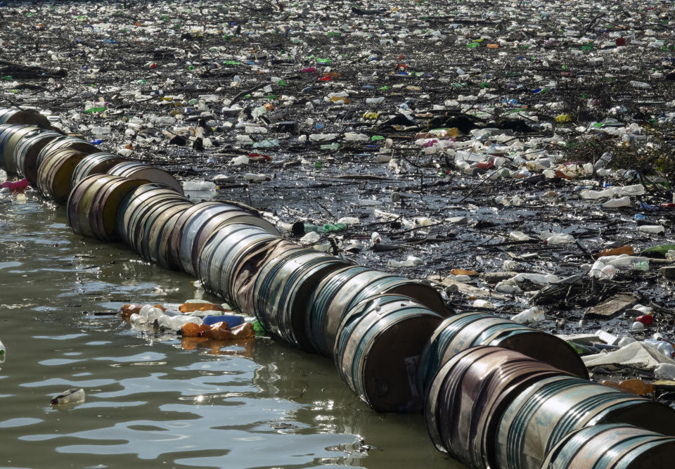 Plastic bottles, wooden planks, rusty barrels and other garbage clogging the Drina river near the eastern Bosnian town of Visegrad, Bosnia, Tuesday, Jan. 5, 2021. Further upstream, the Drina tributaries in Montenegro, Serbia and Bosnia are carrying even more waste after the swollen rivers surged over the the landfills by their banks. The Balkan nations have poor waste management and tons of garbage routinely end up in rivers. (AP Photo/Eldar Emric)