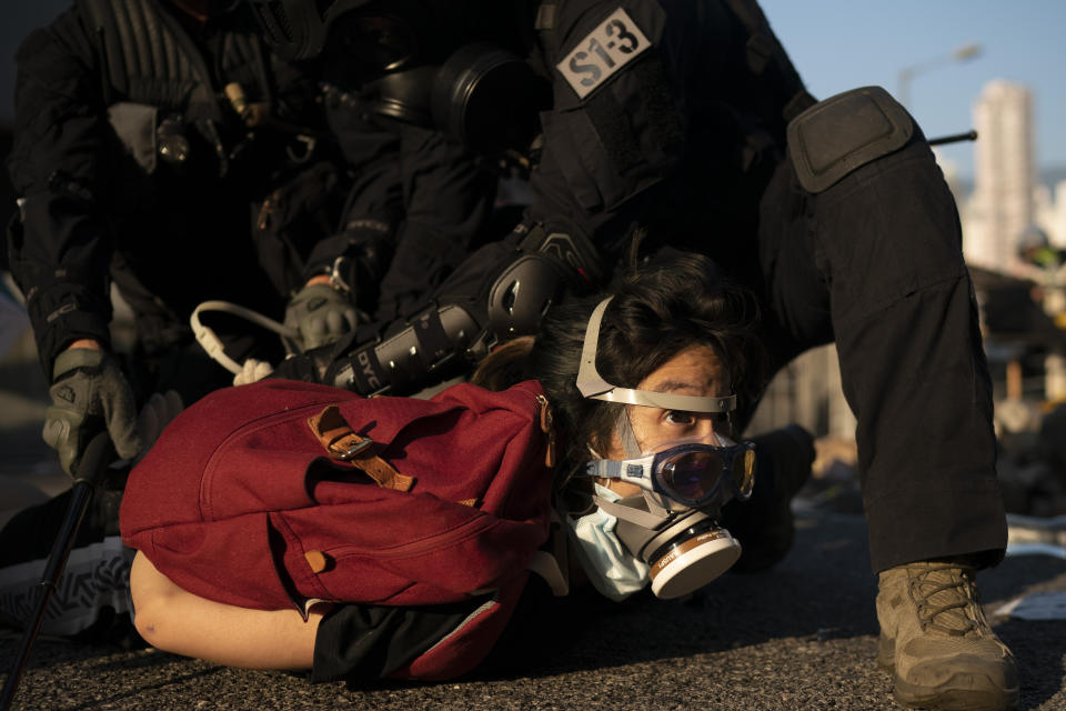 Police detain an anti-government protester in Hong Kong, Oct. 1, 2019. Thousands of black-clad protesters marched in central Hong Kong as part of multiple pro-democracy rallies Tuesday urging China's Communist Party to "return power to the people" as the party celebrated its 70th year of rule. (Photo: Felipe Dana/AP)