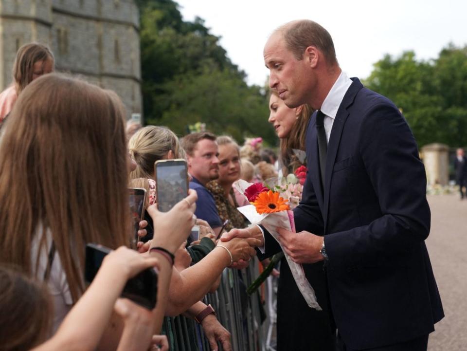 Britain's Prince William, Prince of Wales chats with well-wishers on the Long walk at Windsor Castle on September 10, 2022, two days after the death of Britain's Queen Elizabeth II at the age of 96. - King Charles III pledged to follow his mother's example of "lifelong service" in his inaugural address to Britain and the Commonwealth on Friday, after ascending to the throne following the death of Queen Elizabeth II on September 8. (Photo by Kirsty O'Connor / POOL / AFP) (Photo by KIRSTY O'CONNOR/POOL/AFP via Getty Images)