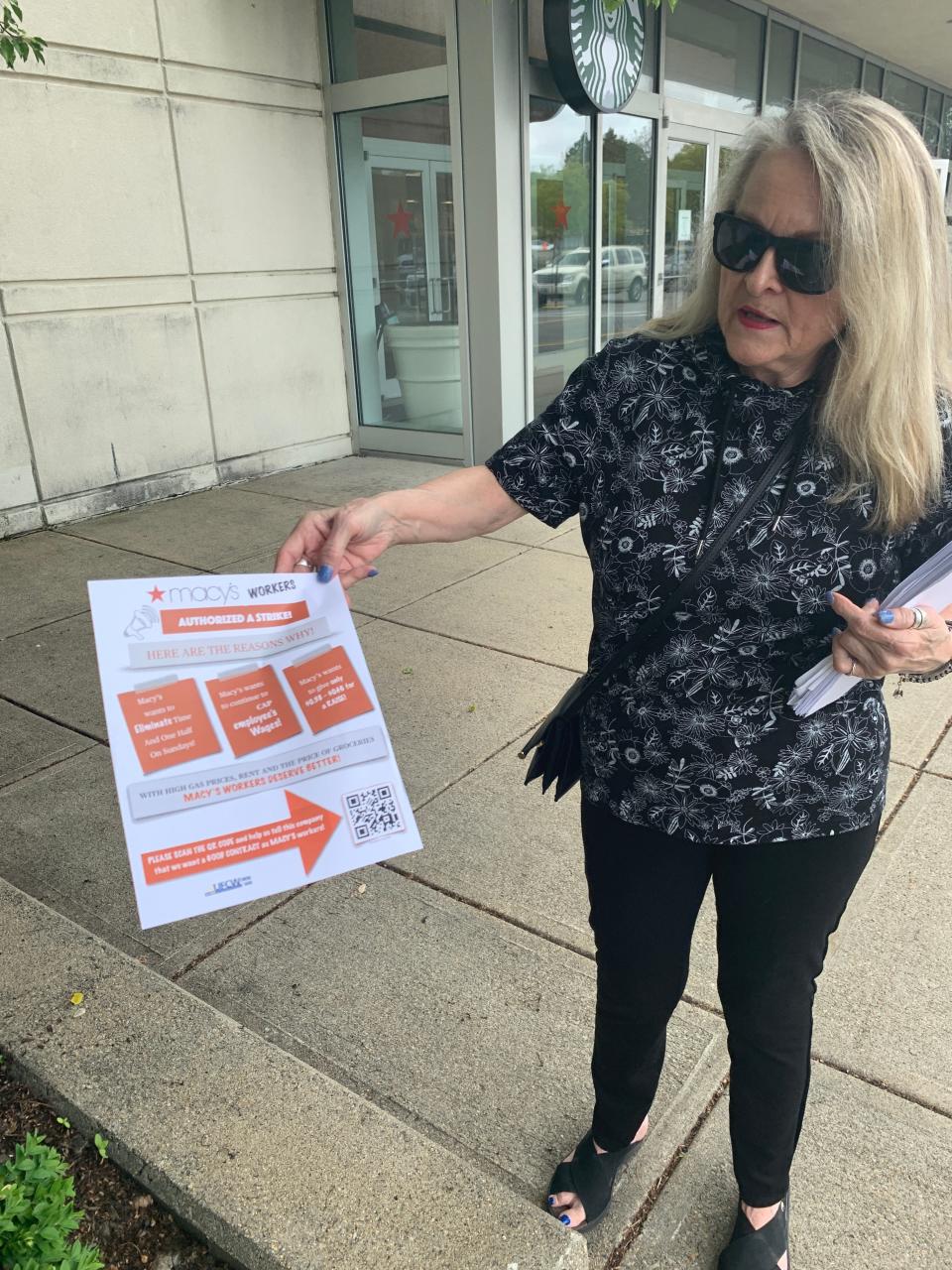 Union negotiating team member Anita Hovey holds a pamphlet she handed out to Macy's customers in Warwick after the union authorized a strike.