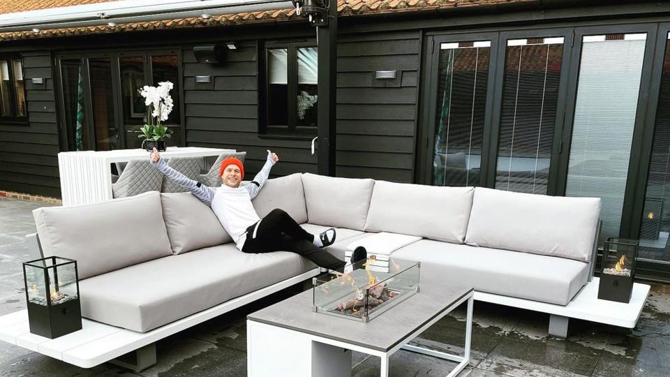 Olly Murs sitting on an outdoor sofa in the winter