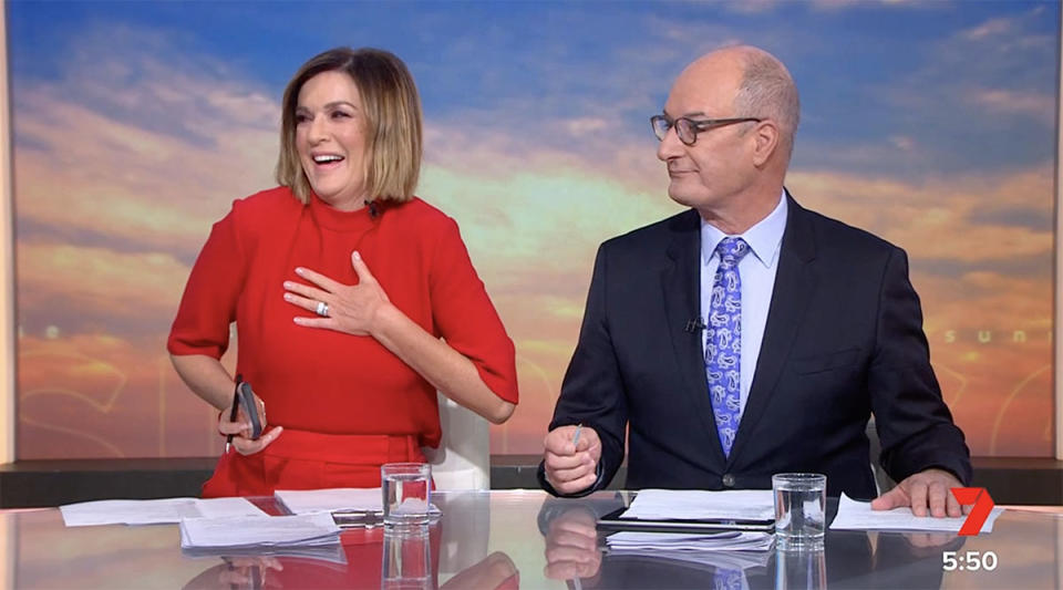 Kylie Gillies holds her phone and laughs while Kochie looks on