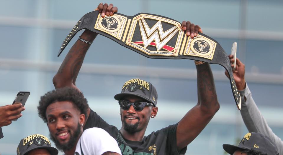 Bobby Portis holds up the Bucks' custom-made WWE championship belt during the team's celebration parade on Thursday, July 22, 2021, in Milwaukee. WWE gifted the title belt to the Bucks to honor the team's NBA championship.