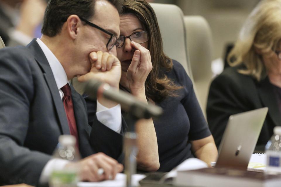 Executive Director of the Board of Elections Kim Strach, right, talks to general counsel Josh Lawson during a public evidentiary hearing on the 9th Congressional District investigation at the North Carolina State Bar in Raleigh, N.C., Monday, Feb. 18, 2019. (Juli Leonard/The News & Observer via AP, Pool)