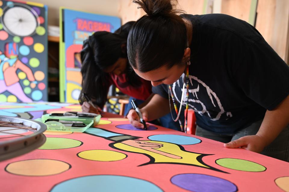 Two of the 12 artists put the finishing touches on public art that will be displayed in Tama-Toledo during RAGBRAI.