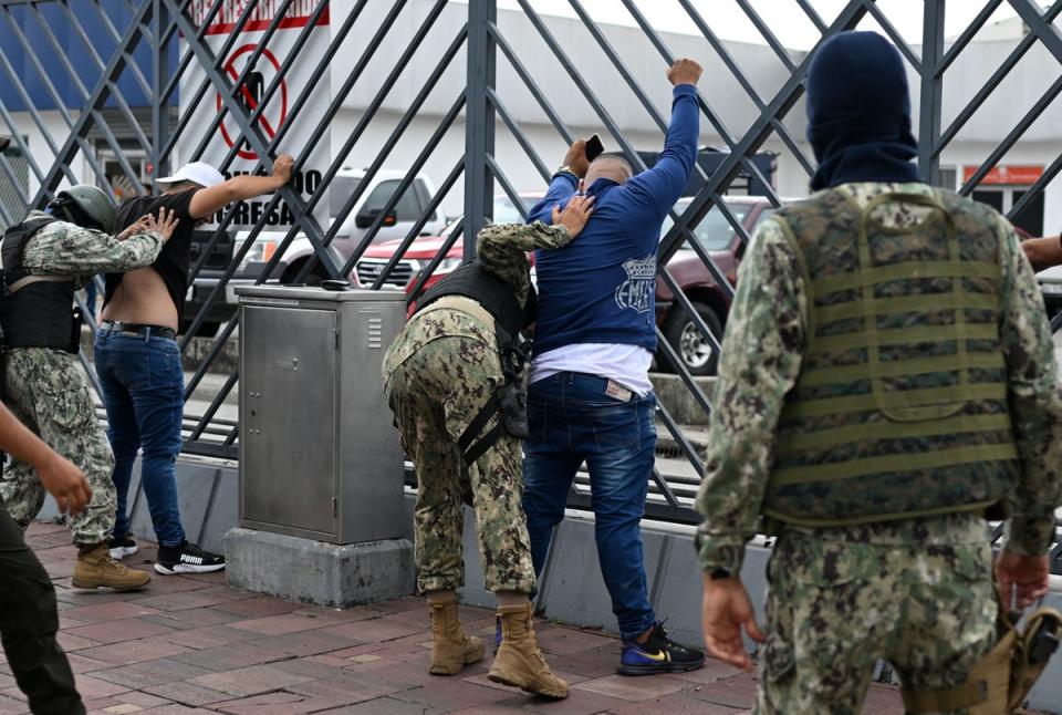 Soldiers frisk two men suspected of belonging to a criminal gang in Guayaquil (AFP/Getty)