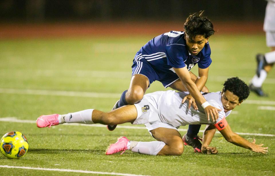 Naples' Aaron Cardenas (20) and Golden Gate's Jonathan Euceda (15) battle for the ball during the boys soccer game between Golden Gate and Naples on Wednesday, Jan. 26, 2022 at Naples High School in Naples, Fla. 