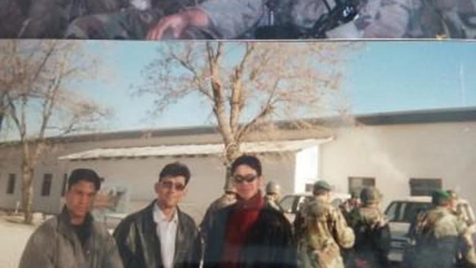 Satary, around 19, in a helicopter (possibly a Chinook) during an Afghan Army training exercise near Kabul, circa 2004. Satary, born without a birth certificate, has some difficulty pinpointing his exact age at different stages of his life; Bottom: Satary posing with two other Afghan interpreters outside an Afghan Army battalion base, waiting for American training teams to arrive, circa 2003. (Courtesy Hasib Satary)