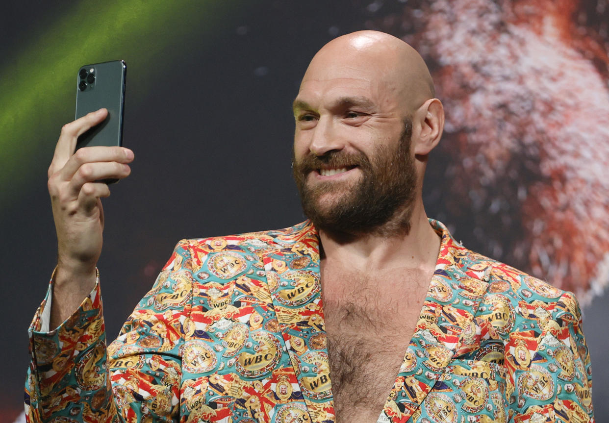 LAS VEGAS, NEVADA - OCTOBER 06:  WBC heavyweight champion Tyson Fury records himself on a cell phone during a news conference at MGM Grand Garden Arena on October 6, 2021 in Las Vegas, Nevada. Fury will defend his title against Deontay Wilder on October 9 at T-Mobile Arena in Las Vegas.  (Photo by Ethan Miller/Getty Images)