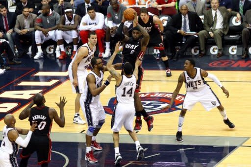 LeBron James (with ball) of the Miami Heat during the NBA game against the New Jersey Nets on April 16. Miami defeated host New Jersey 101-98