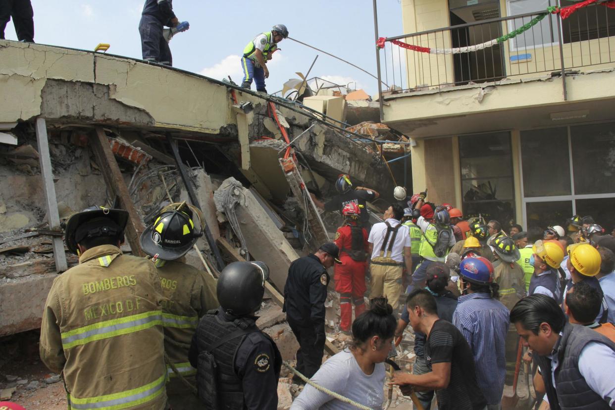 Rescue workers search for children trapped inside the collapsed Enrique Rebsamen school in Mexico City on Sept. 19, 2017: AP Photo/Carlos Cisneros