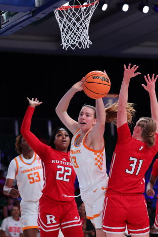 In this photo provided by Bahamas Visual Services, Tennessee's Marta Suarez, front center, handles the ball against Rutgers' Kassondra Brown (22) and Abby Streeter (31) during an NCAA college basketball game in the Battle 4 Atlantis, Saturday, Nov. 19, 2022, at Atlantis in Paradise Island, Bahamas. (Tim Aylen/Bahamas Visual Services via AP)