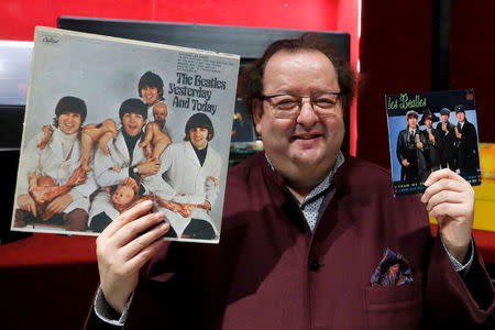 French Beatles specialist and collector Jacques Volcouve, one of the world's greatest living experts of the band, poses with the " Yesterday And today " and "From Me To You" covers at Drouot auction house in Paris, March 16, 2017, a part of the 15,000 items going on sale on next March 18. REUTERS/Charles Platiau