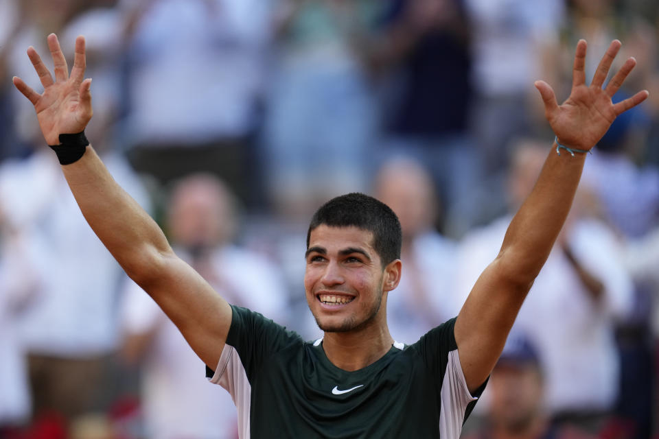 Carlos Alcaraz celebrates after defeating Novak Djokovic during a men's semifinal at the Mutua Madrid Open tennis tournament in Madrid, Spain, Saturday, May 7, 2022. (AP Photo/Manu Fernandez)