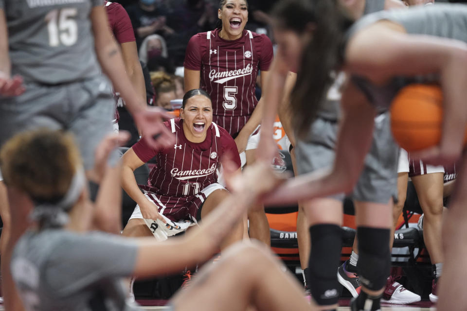 South Carolina guard Destiny Littleton (11) and South Carolina forward Victaria Saxton (5) cheer on their teammates during the second half of an NCAA college basketball game against Vanderbilt Monday, Jan. 24, 2022, in Columbia, S.C. South Carolina won 85-30. (AP Photo/Sean Rayford)