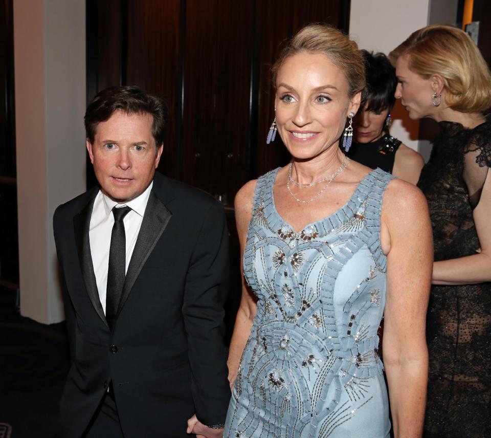 Michael J. Fox, left, and Tracy Pollan pose in the audience at the 71st annual Golden Globe Awards at the Beverly Hilton Hotel on Sunday, Jan. 12, 2014, in Beverly Hills, Calif. (Photo by Matt Sayles/Invision/AP)