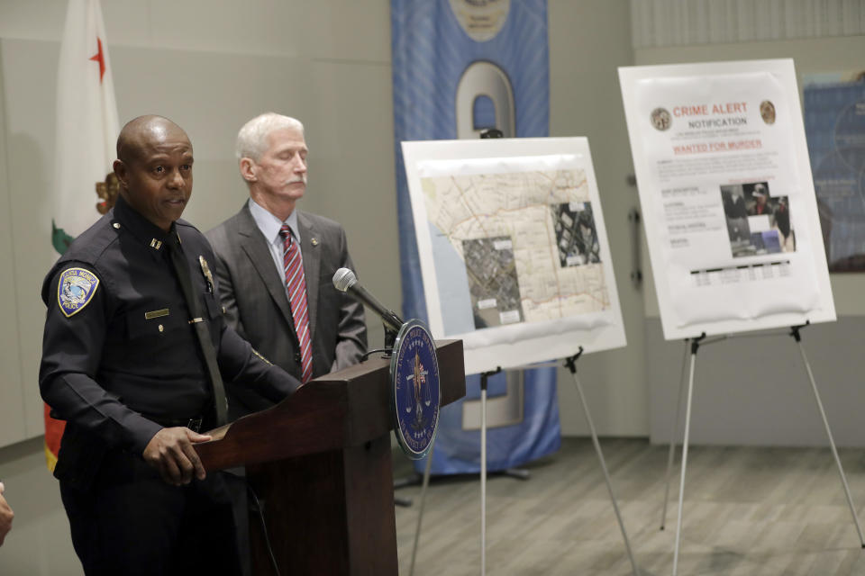 Santa Monica PD Capt. Wendell Shirley, left, speaks at LAPD headquarters Tuesday, Sept. 25, 2018, in Los Angeles. A man arrested on suspicion of beating a Southern California homeless man into unconsciousness and suspected in six other attacks — three of them fatal — also was being investigated in the disappearances of two of the suspect's Texas relatives, officials said Tuesday. (AP Photo/Marcio Jose Sanchez)