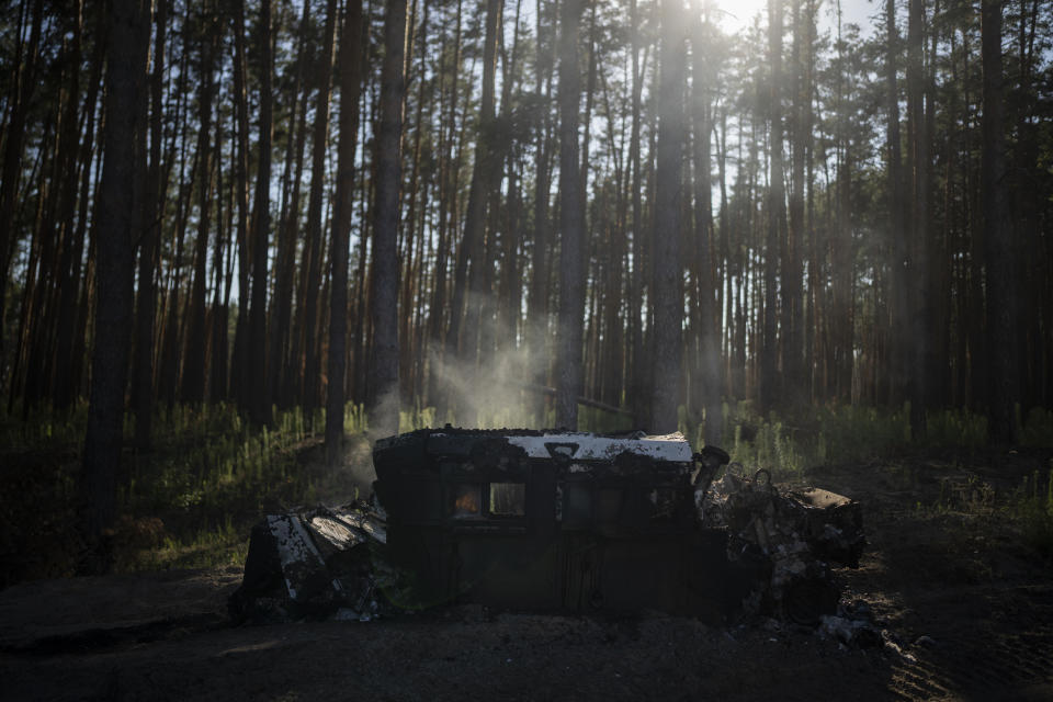 FILE - Smoke is rises from a burning humvee vehicle on the front line in the outskirts of Lyman, Ukraine, Tuesday, Aug. 15, 2023. Moscow’s army is staging a ferocious push in northeast Ukraine designed to distract Ukrainian forces from their counteroffensive and minimize the number of troops Kyiv is able to send to more important battles in the south. (AP Photo/Bram Janssen, File)