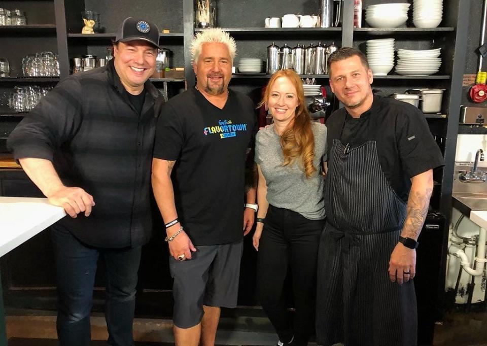"DDD" series' 2021 visit to north county: Food Network star Guy Fieri, second from left, poses for a photo with chef Tim Lipman, right, and Jenny Lipman, owners of Coolinary Café in Palm Beach Gardens. They are joined by star chef Rocco DiSpirito.