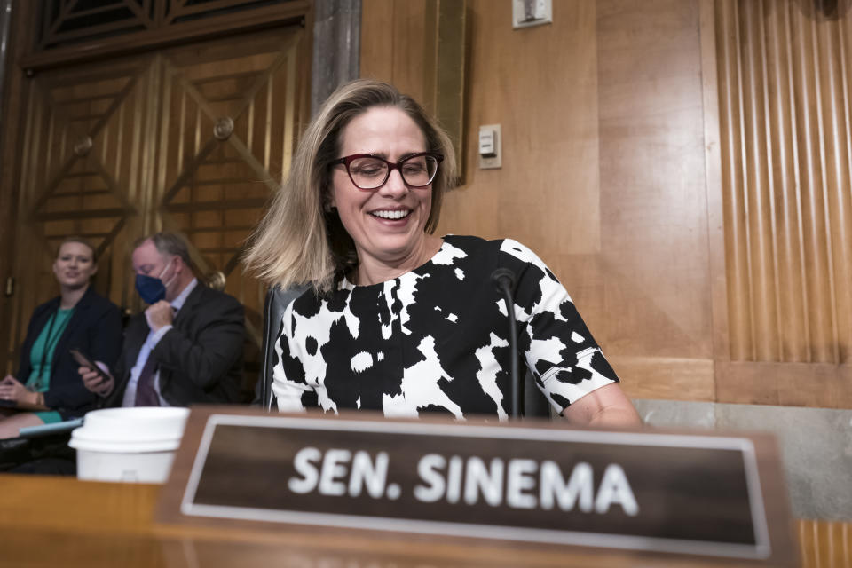 FILE - Sen. Kyrsten Sinema, D-Ariz., arrives for a meeting of the Senate Homeland Security Committee at the Capitol in Washington, Wednesday, Aug. 3, 2022. Democrats pushed their election-year economic package to Senate passage Sunday, Aug. 7, 2022, a compromise less ambitious than Biden’s original domestic vision but one that still meets party goals of slowing global warming, moderating pharmaceutical costs and taxing immense corporations. (AP Photo/J. Scott Applewhite, File)