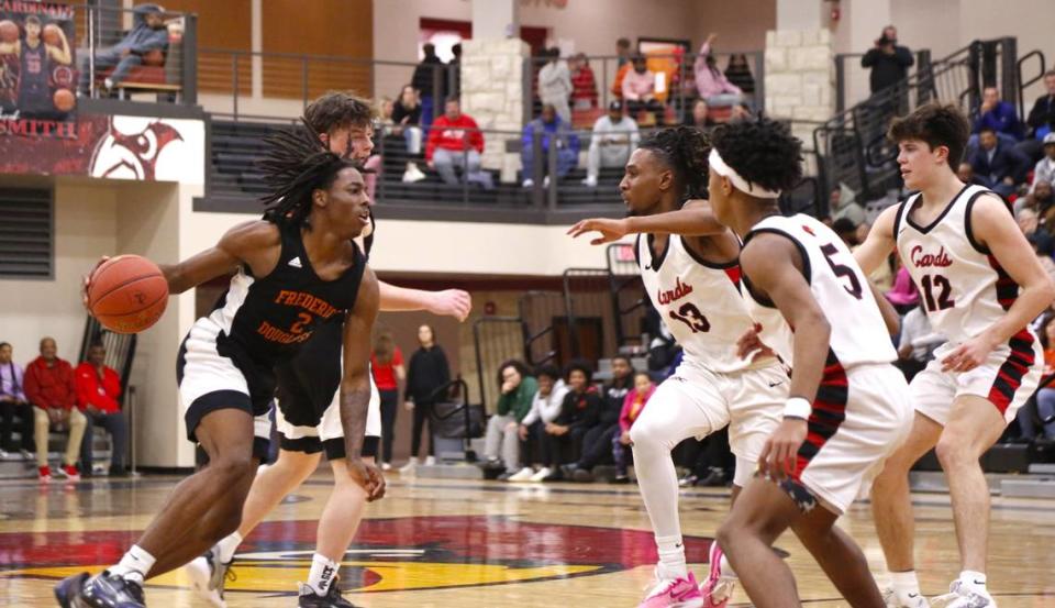 Frederick Douglass guard Aveion Chenault faced a trio of George Rogers Clark defenders on his way up court, led by Breland Morrison (13) along with Malachi Ashford (5) and JP Gaines (12) during the Cardinals 56-50 win over the Broncos at GRC Arena in Winchester on Tuesday.