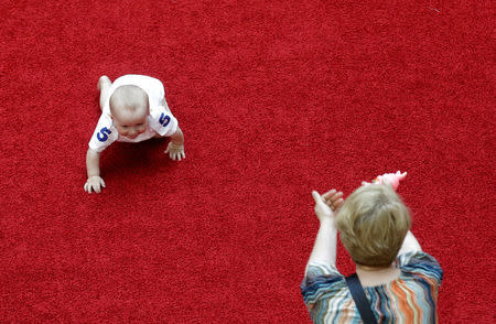 A mother reacts as her baby takes place in the Baby Race to mark international Children's Day in Vilnius, Lithuania, June 1, 2016. REUTERS/Ints Kalnins