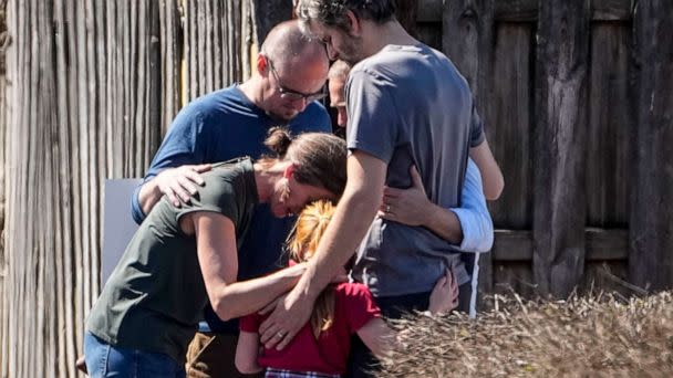 PHOTO: A group prays with a child outside the reunification center at the Woodmont Baptist church after a school shooting, Mar. 27, 2023, in Nashville, Tenn. (John Bazemore/AP)