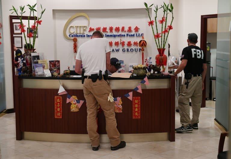 FBI agents search the offices of the California Investment Immigration Fund during an investigation into an alleged US$50 million high-end visa fraud scheme involving as many as 100 Chinese nationals in San Gabriel