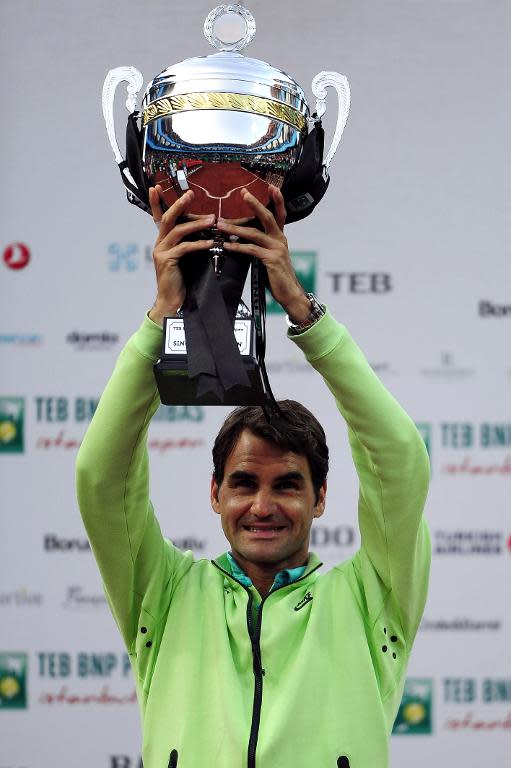 Switzerland's Roger Federer lifts the trophy after defeating Pablo Cuevas of Uruguay in the men's final of the ATP Istanbul Open in Istanbul on May 3, 2015