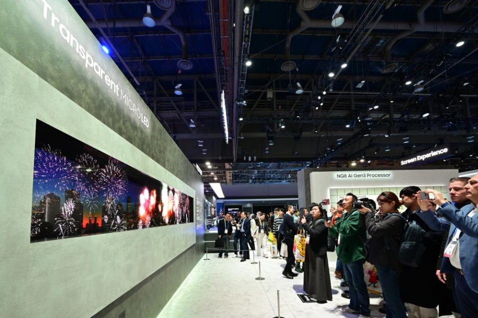 Attendees at CES 2024 in Las Vegas look at Samsung's transparent Micro LED display in the tech giant's booth at the Las Vegas Convention Center.