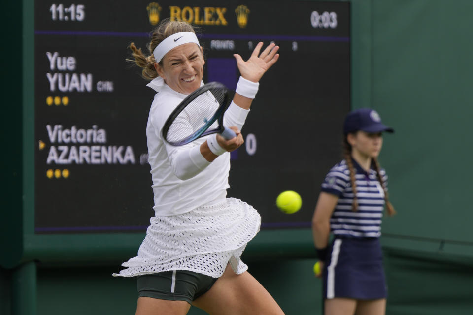 Victoria Azarenka of Belarus plays a return to China's Yuan Yue during the first round women's singles match on day one of the Wimbledon tennis championships in London, Monday, July 3, 2023. (AP Photo/Alastair Grant)