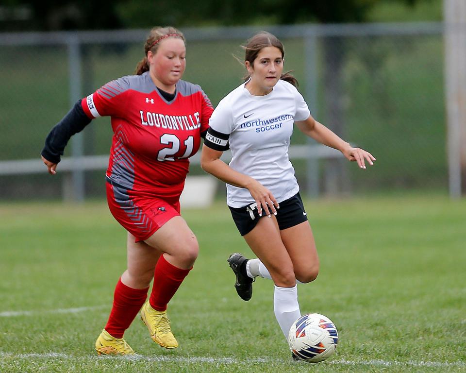 Northwestern High School's Sydney McConahay (17) works the ball down field against Loudonville High School's Mackenzie Haun (21) during high school girls soccer action in Loudonville Thursday, Sept. 29, 2022. TOM E. PUSKAR/ASHLAND TIMES-GAZETTE