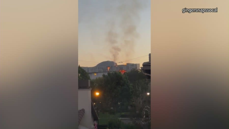 An active flare-up of a fire seen on the doors of a historic airbase hangar in Tustin on Nov. 11 has prompted concerns from residents. (gingersnapssocal)