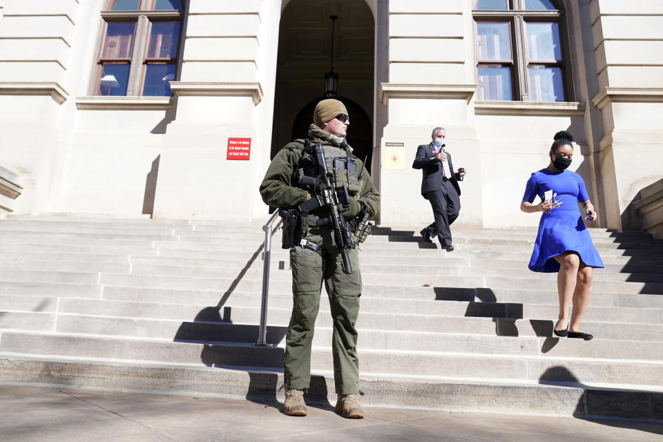 A Georgia State Patrol S.W.A.T. team member stands guard outside the Georgia State Capitol building Thursday, Jan. 14, 2021, in Atlanta. Governors in some states have called out the National Guard, declared states of emergency and closed their capitols over concerns about potentially violent protests. Though details remain murky, demonstrations are expected at state capitols beginning Sunday and leading up to President-elect Joe Biden's inauguration on Wednesday. (AP Photo/John Bazemore)