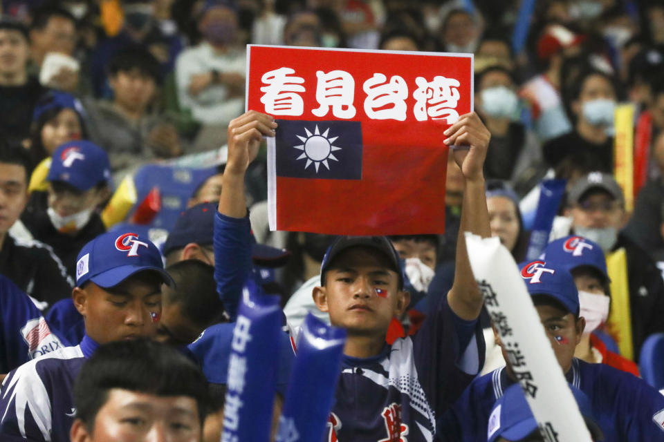 A supporter of Taiwan team holds up the Taiwan flag with the words "See Taiwan" during a Pool A game between Taiwan and Panama at the World Baseball Classic (WBC) held at Taichung Intercontinental Baseball Stadium in Taichung, Taiwan, Wednesday, March 8, 2023 (AP Photo/I-Hwa Cheng)