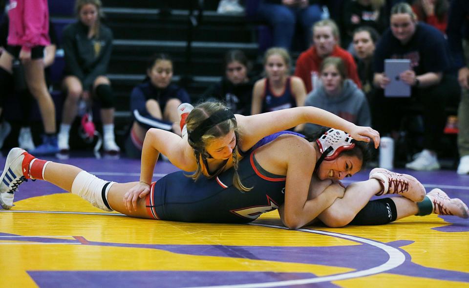 Nevada's Mackenzi Olsen (top) and Ballard's Ava Vance wrestle at 120 pounds during the Central Iowa Kickoff Girls Wrestling Tournament at the Nevada High School Field House on Saturday, Nov. 18, 2023, in Nevada, Iowa.