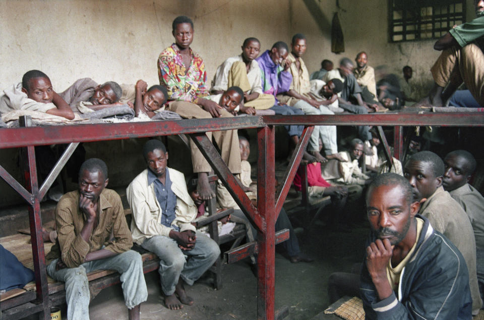 FILE - Some of the 334 inmates in a prison who are accused of committing war crimes and participating in the genocide, sit in the prison in Kibungo, Rwanda, Aug. 17, 1994. (AP Photo/Javier Bauluz, File)