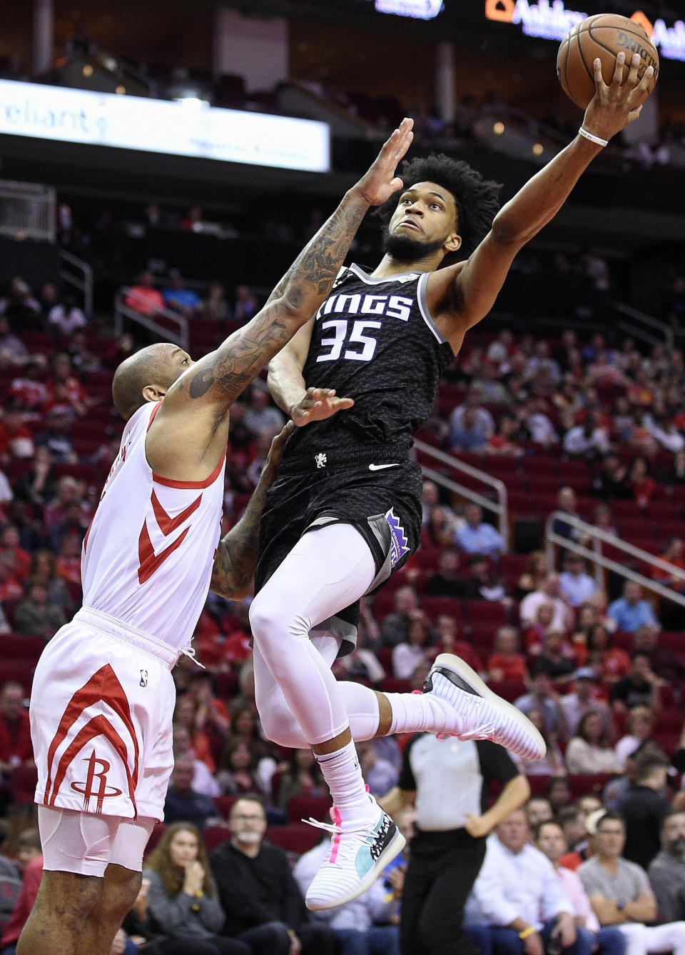 Sacramento Kings forward Marvin Bagley III (35) drives to the basket as Houston Rockets forward PJ Tucker defends during the first half of an NBA basketball game, Saturday, March 30, 2019, in Houston. (AP Photo/Eric Christian Smith)